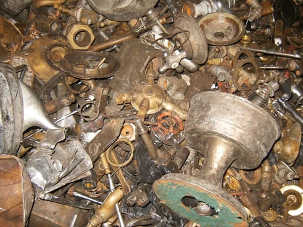 Scrap metal pile with various rusted and used metals, ideal for recycling and trading.