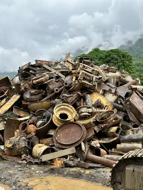 Scrap metal pile with various rusted metal parts and machinery components.