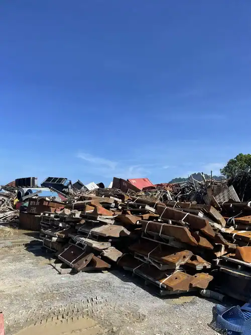 Piles of rusted scrap metal at a commercial industrial recycling yard.
