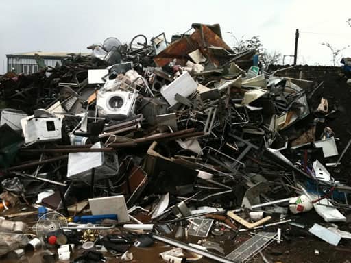 Pile of assorted scrap metal and electronic waste for recycling.