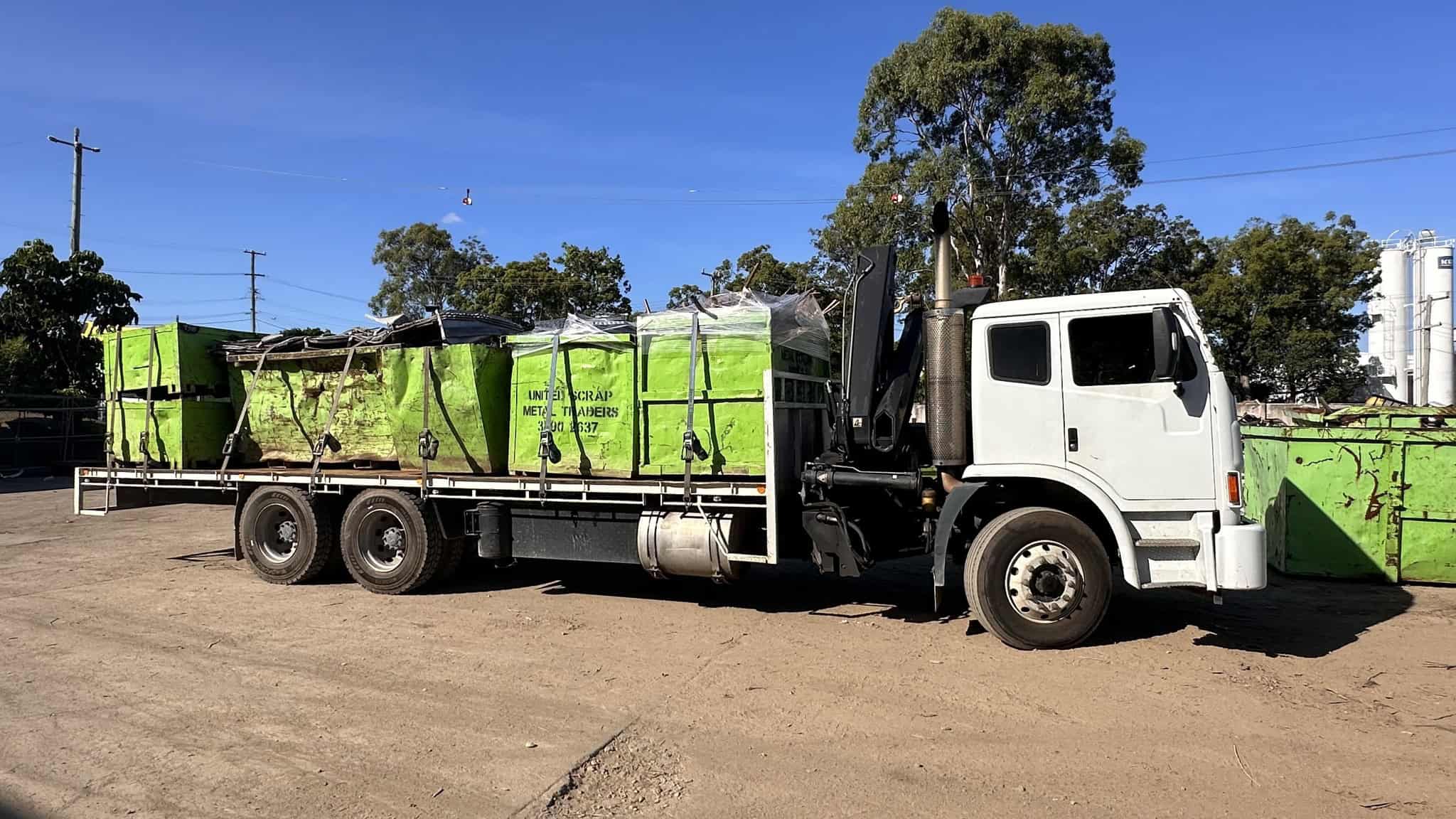 Heavy-duty scrap metal collection truck for recycling services.