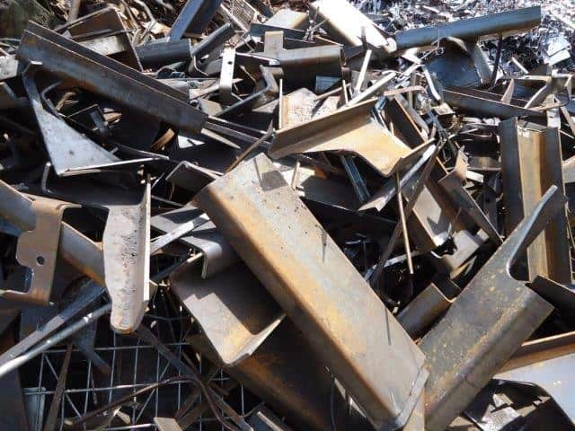 Pile of scrap metal including steel and iron pieces for recycling and trade.