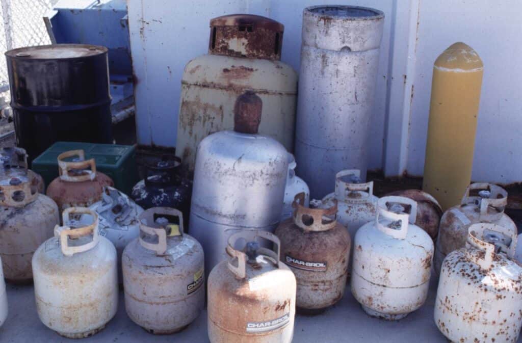 Rusty metal drums and containers for scrap metal recycling.
