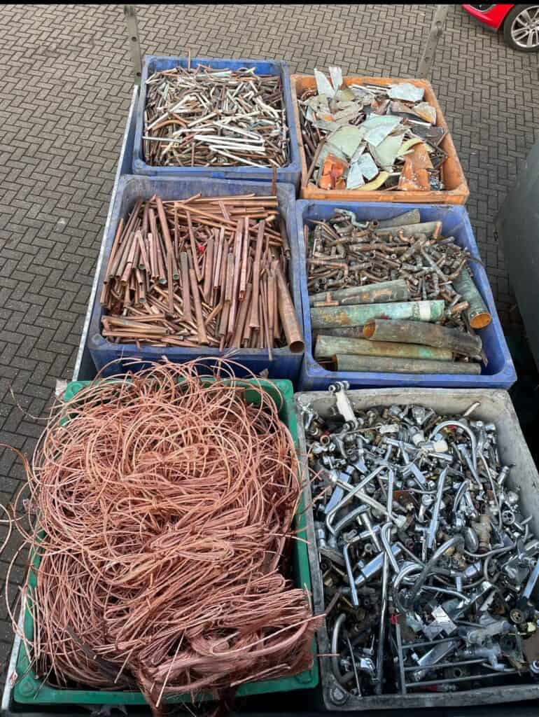 Scrap metal drop-off with copper, steel, and aluminum materials ready for recycling.