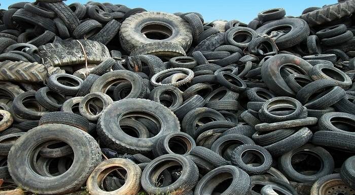 Pile of used tires ready for scrap metal recycling.